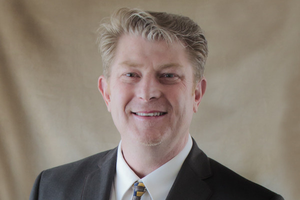 Randall C. Fullem in a Black Suit smiling at the camera